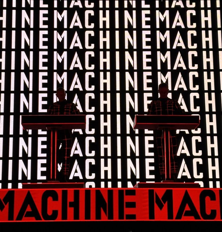 MACHINE, repeated until it fills the entire screen, as Kraftwerk plays "The Man-Machine" at Es Jardí.