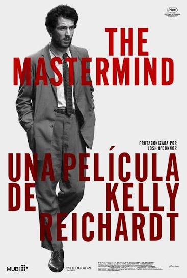 Poster for The Mastermind, directed by Kelly Reichardt: a man in a suit walks across the frame in black and white, with the title and the director's name in large red letters.